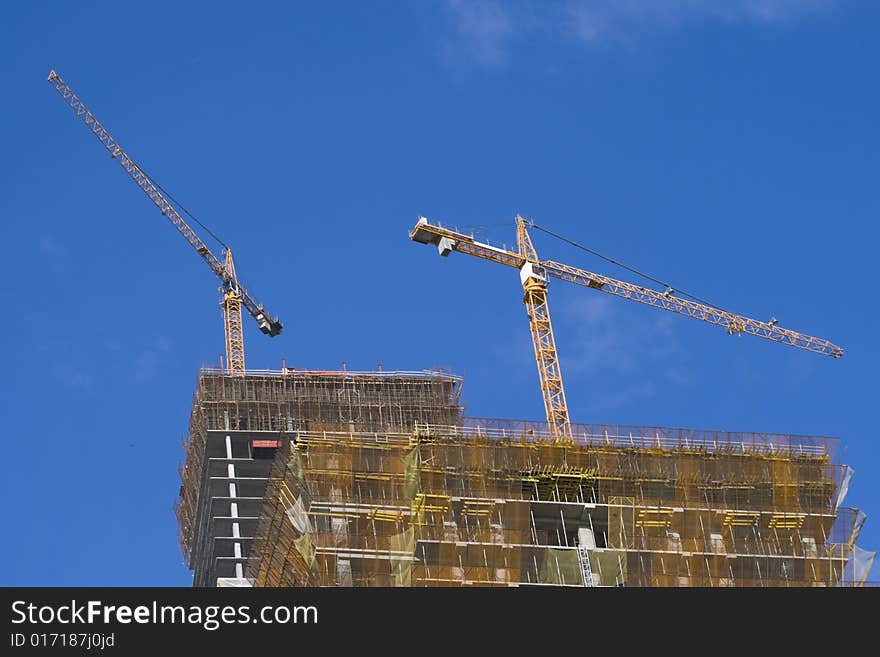 Construction of skyscraper with hoisting crane