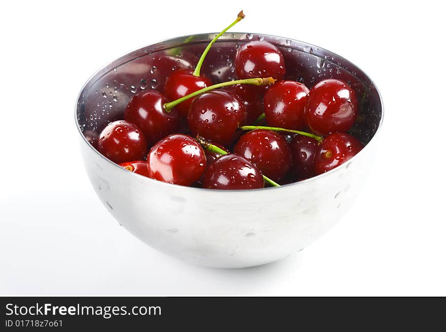 Red cherry in the metal bowl