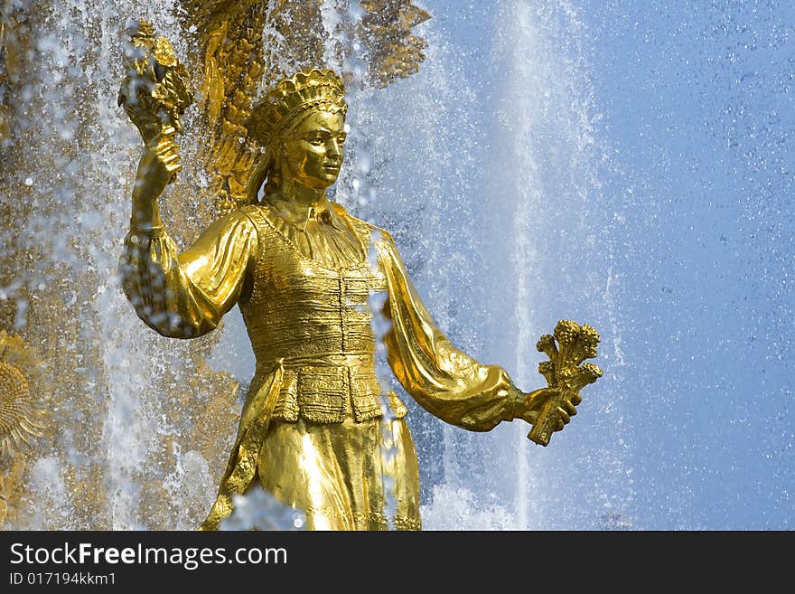 Shining fountain with gold woman's sculpture