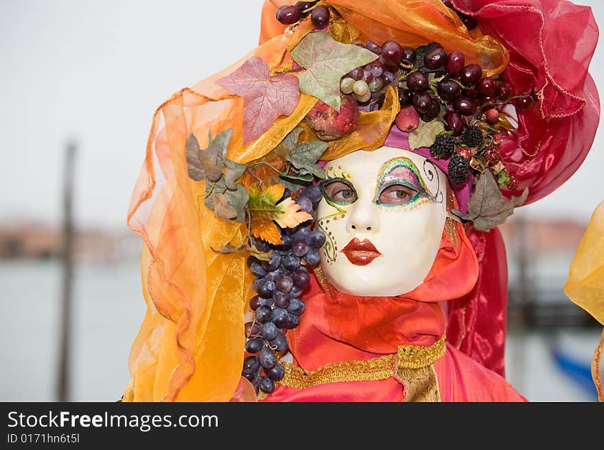 Red and orange costume at the Venice Carnival. Red and orange costume at the Venice Carnival