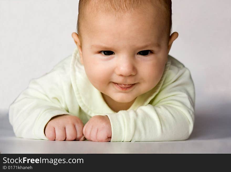 Cute baby with sly eyes puting out his tongue. Cute baby with sly eyes puting out his tongue