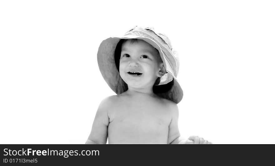 Baby boy in father's hat over white