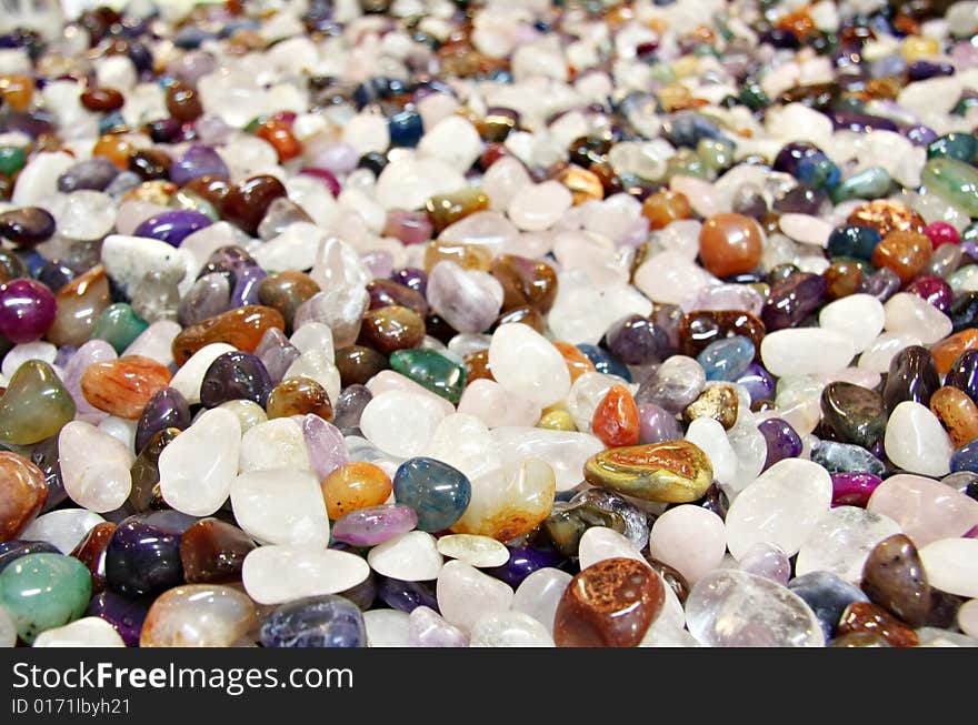 Semi precious stones, shallow dof, focus on the front stones. Semi precious stones, shallow dof, focus on the front stones.