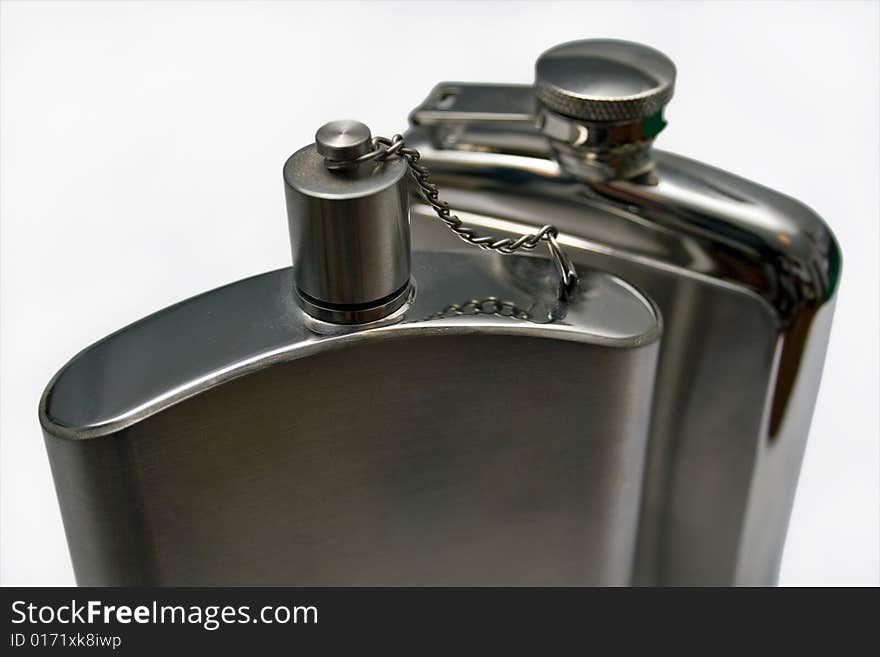 Two metal flasks closeup with a white background