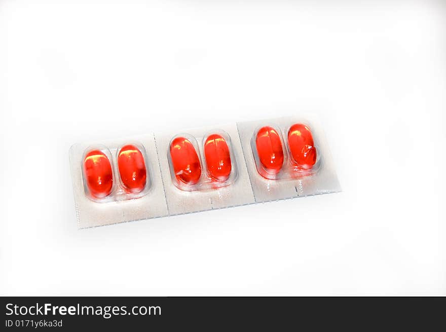 A pack of orange medication pills. A pack of orange medication pills