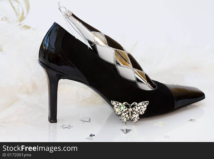 Christmas stilettos with diamante butterfly jewellery and white feathers background. Clipping path included for easy removal. Christmas stilettos with diamante butterfly jewellery and white feathers background. Clipping path included for easy removal.