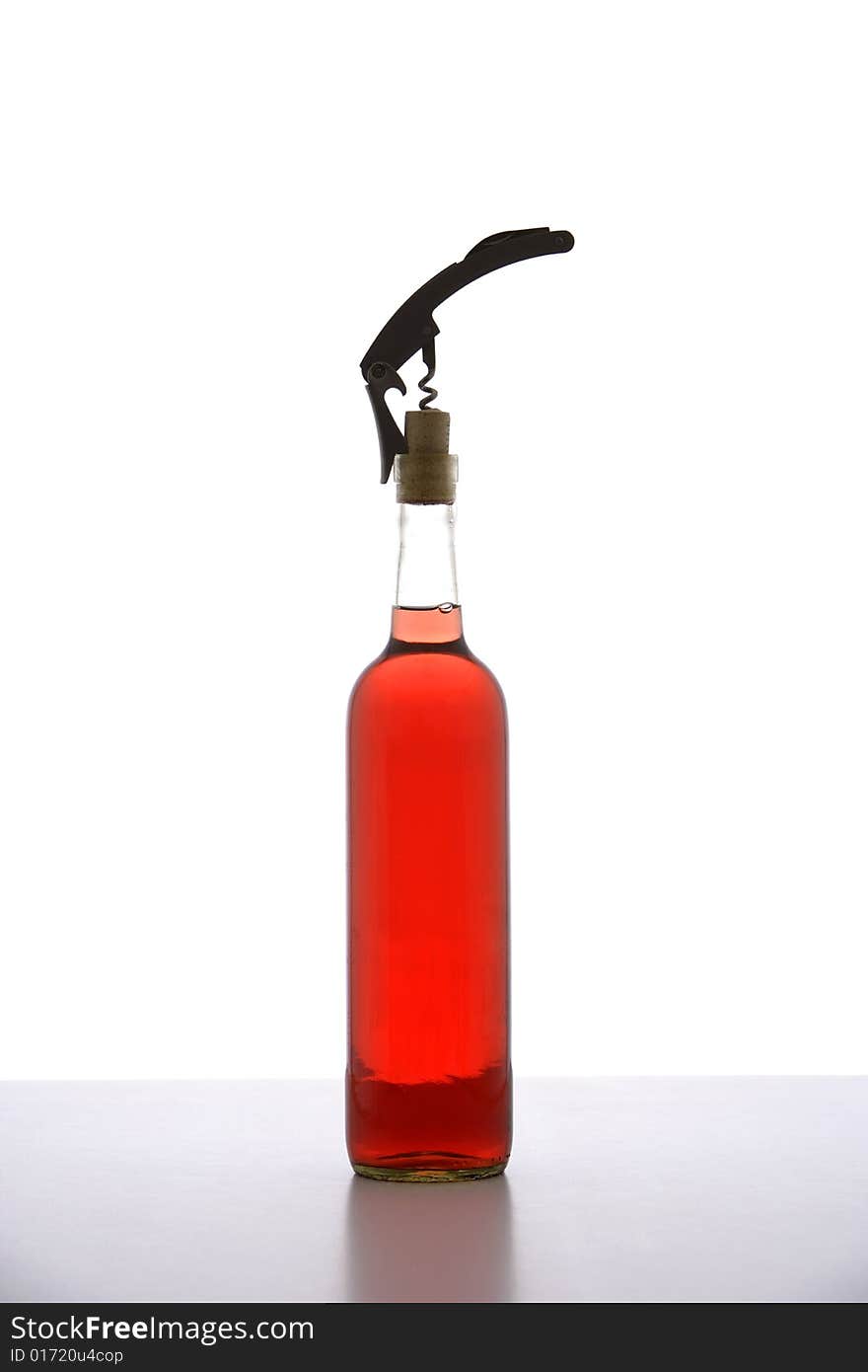 A corkscrew in opening a bottle of wine