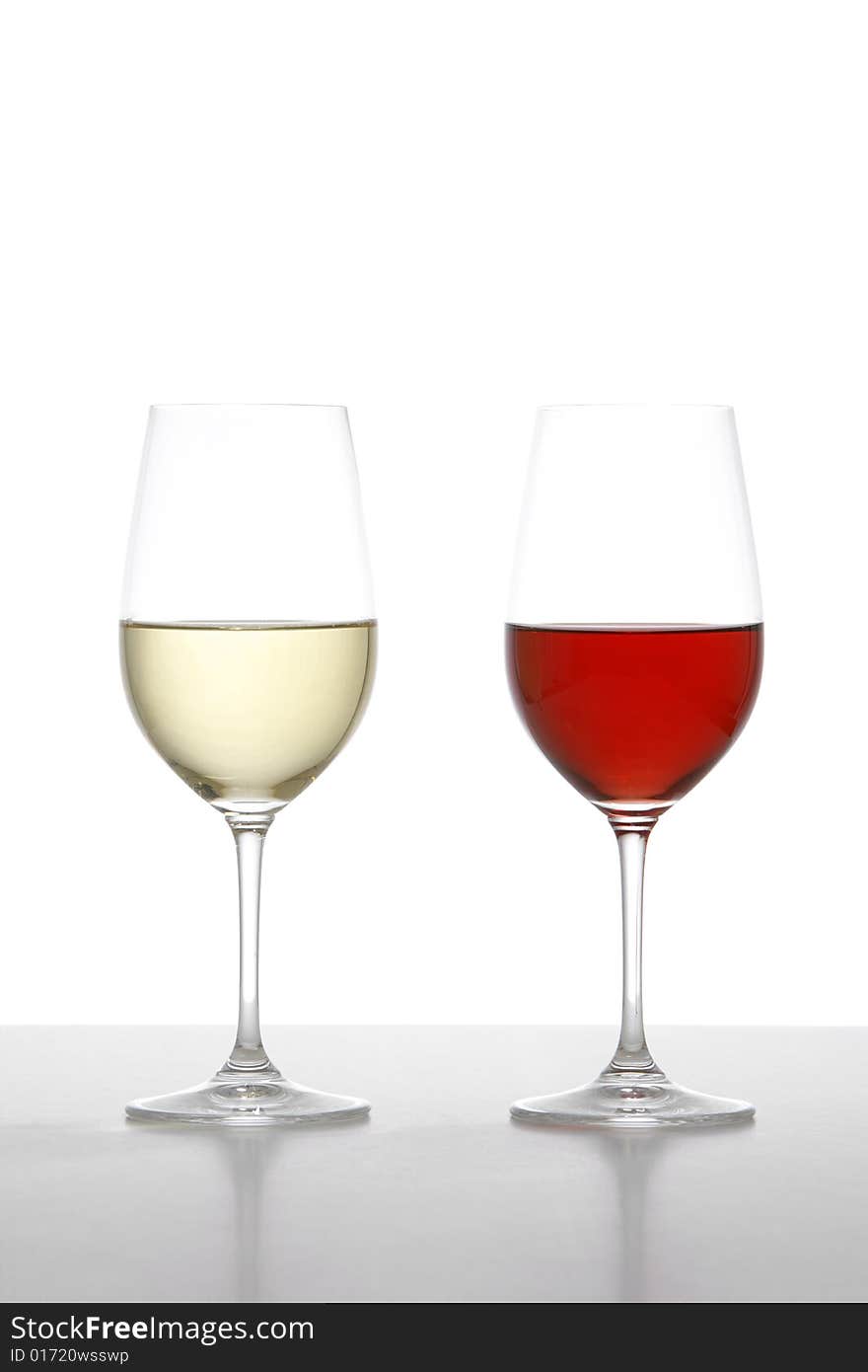 Two wine glasses one red one white in the studio