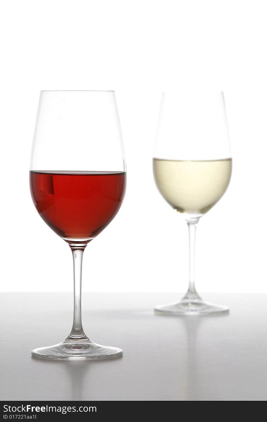 Two wine glasses one red one white in the studio