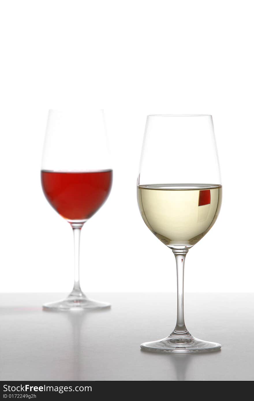 Two wine glasses one red one white in the studio