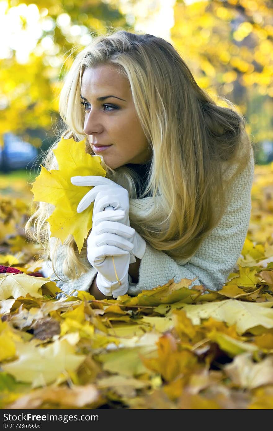 Lady lying on the ground of maple leaves. Lady lying on the ground of maple leaves