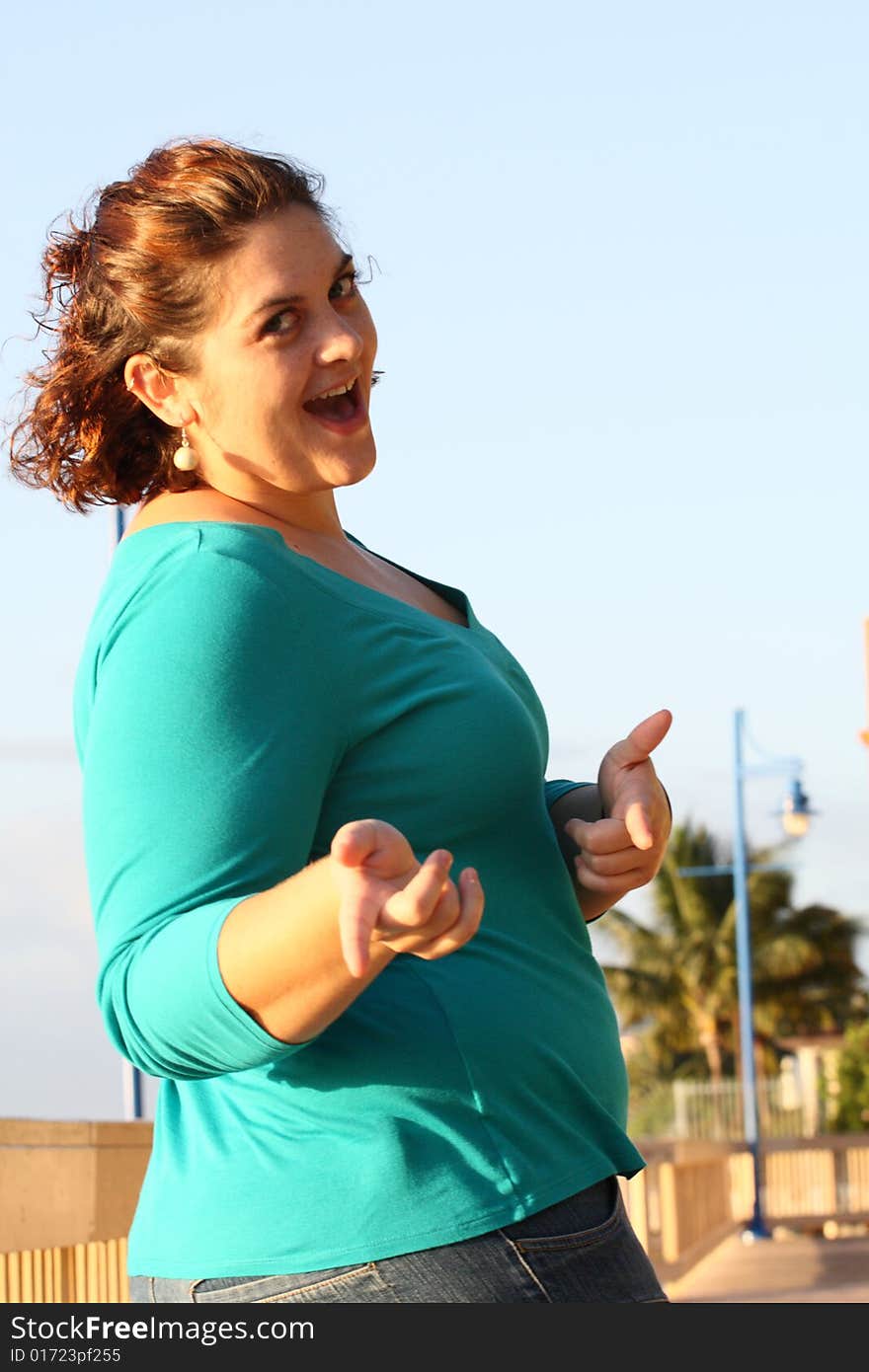 Female pointing at the camera and smiling. Female pointing at the camera and smiling