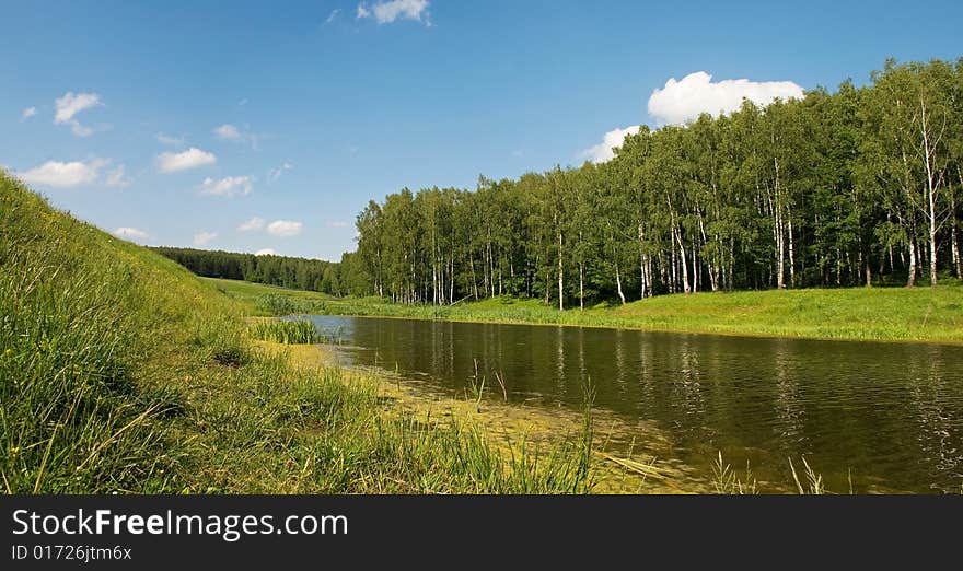 Lake near the forest and meadow.
Sunny day with beautiful sky.
Russia, Summer 2008. Lake near the forest and meadow.
Sunny day with beautiful sky.
Russia, Summer 2008.