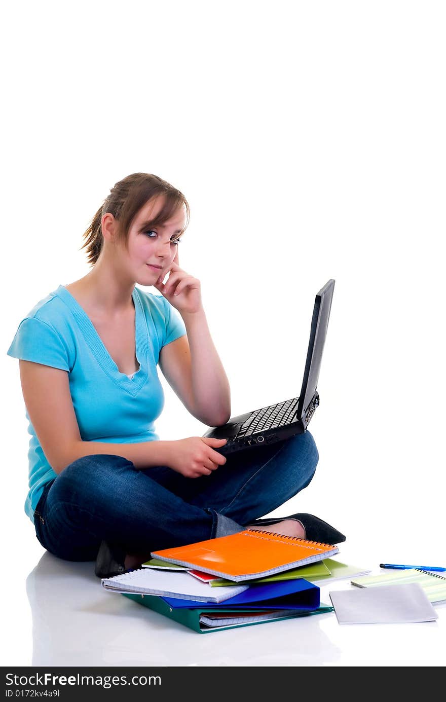 Teenager schoolgirl with laptop on white background