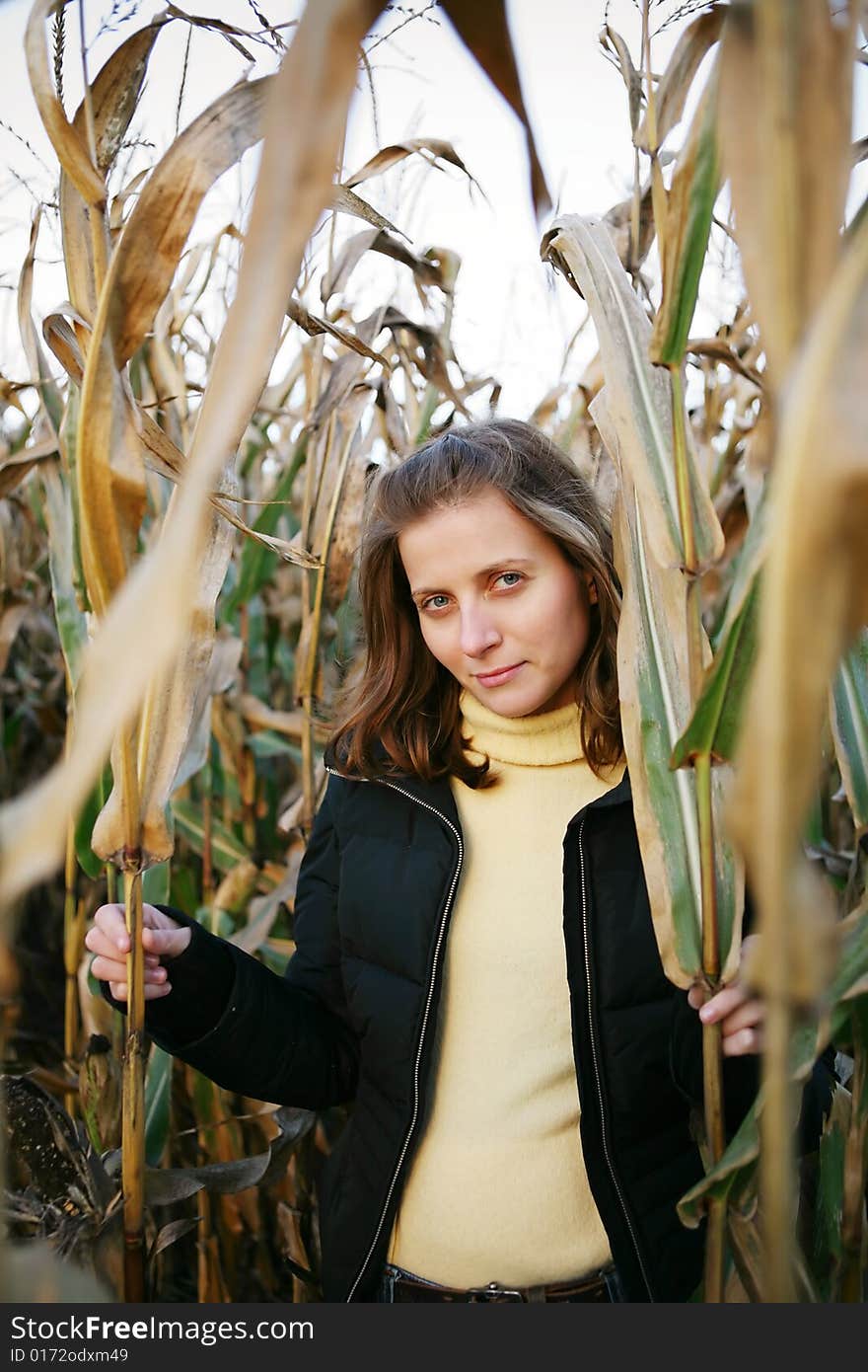 Smiling girl in plant. autumn