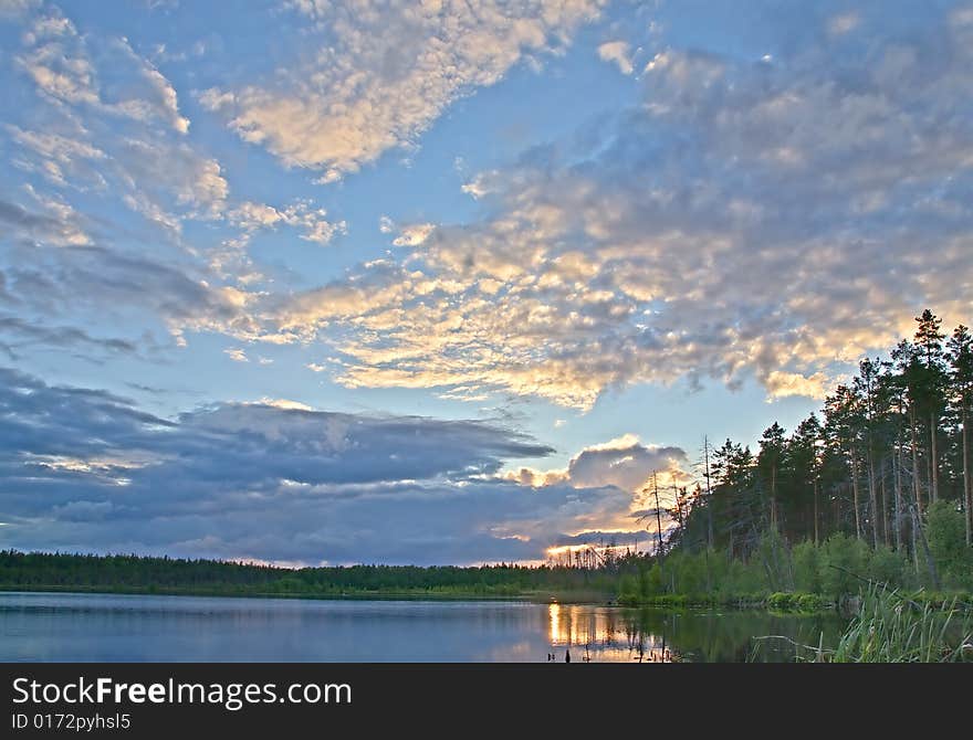 Sunset above small forest lake. Sunset above small forest lake