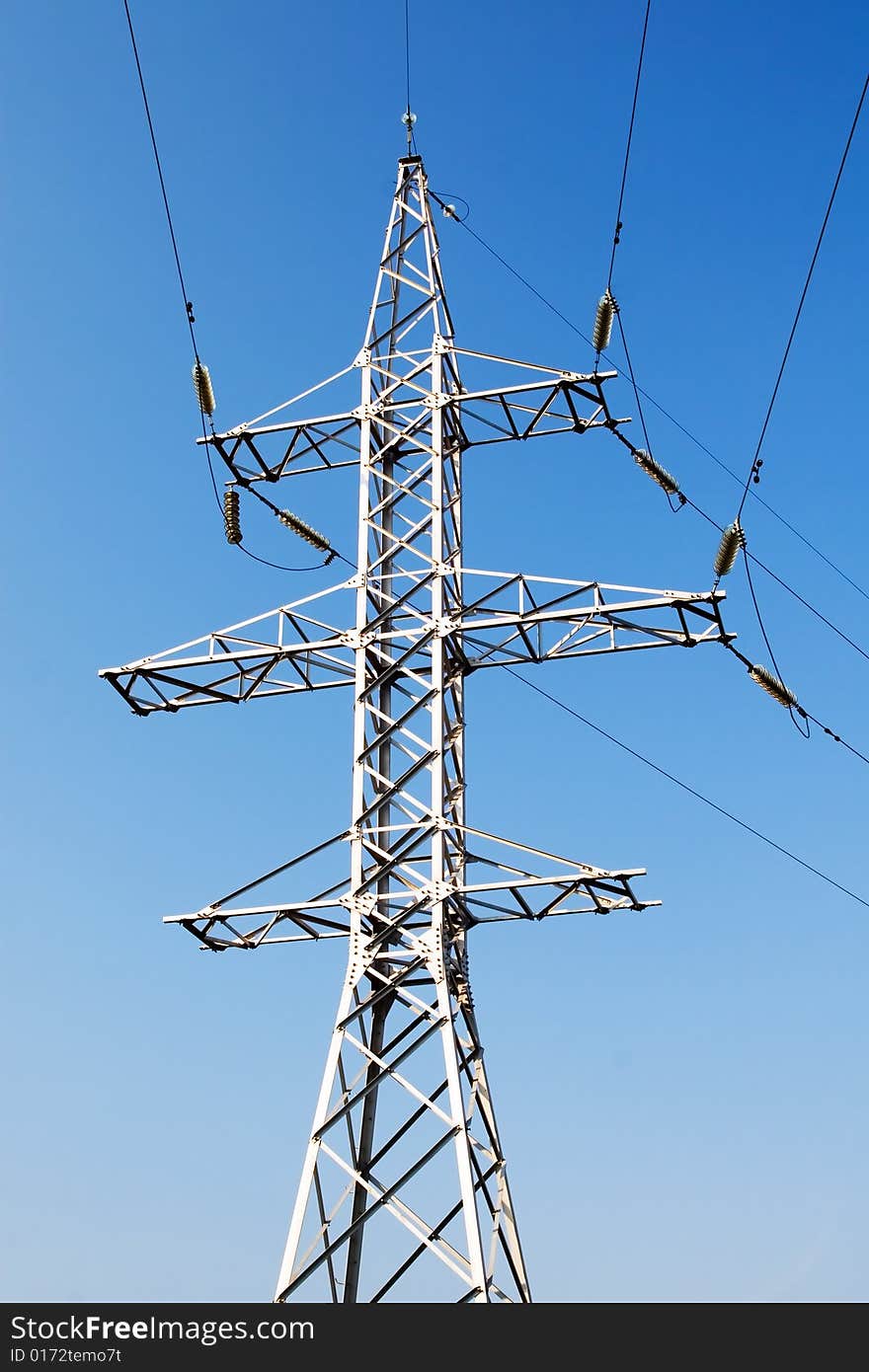 Power lines and electric pylon on a background of sky