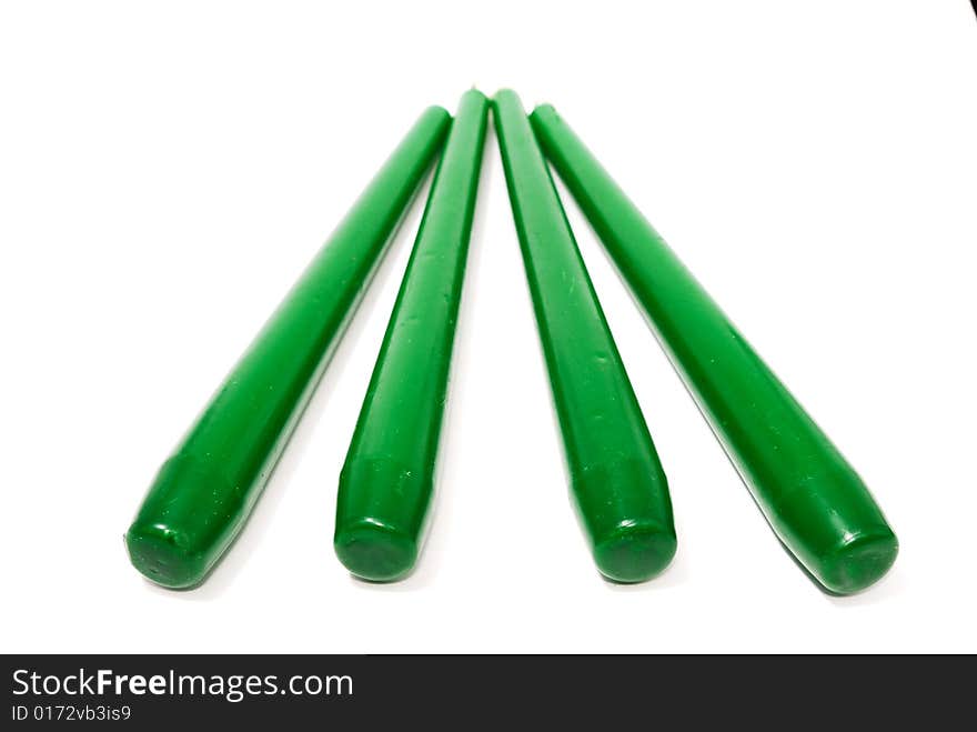 Green candles isolated on white background