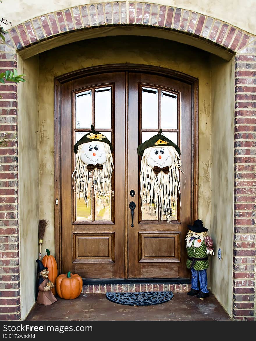 Double Doors decorated with scarecrow faces and other fall decorations. Double Doors decorated with scarecrow faces and other fall decorations.