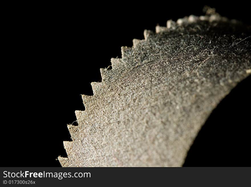 A rusted old saw blade covered in dust. A rusted old saw blade covered in dust