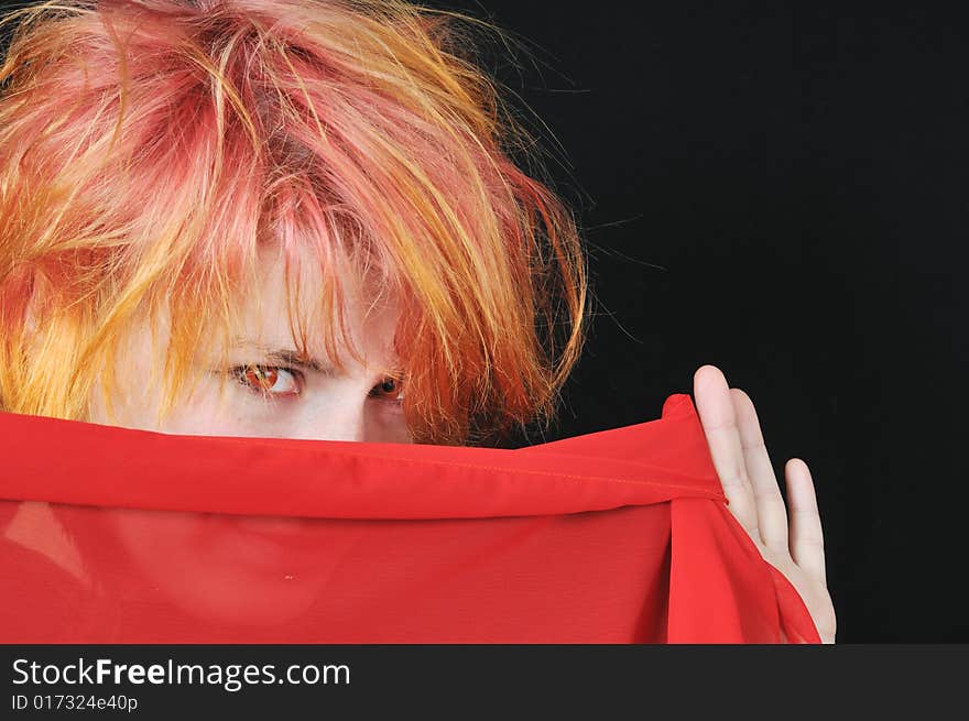 Portrait of the pretty red woman on black background