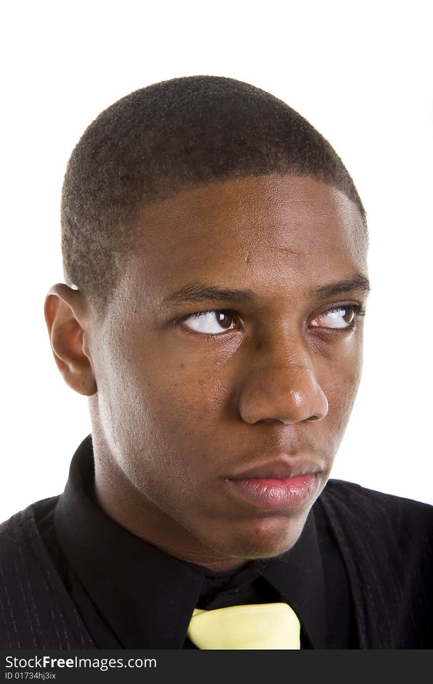 A nice young black man in a blackshirt and yellow tie looking up and left. A nice young black man in a blackshirt and yellow tie looking up and left