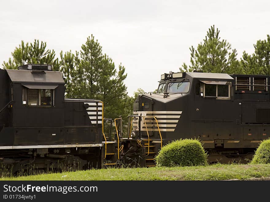 Two black train engines facing each other on track. Two black train engines facing each other on track