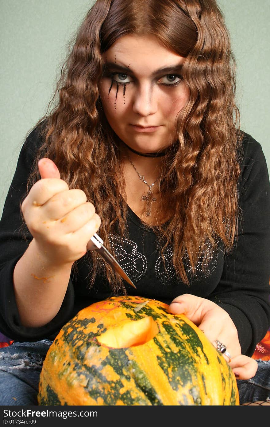 Adorned girl to Halloween c by pumpkin in the hands. Adorned girl to Halloween c by pumpkin in the hands