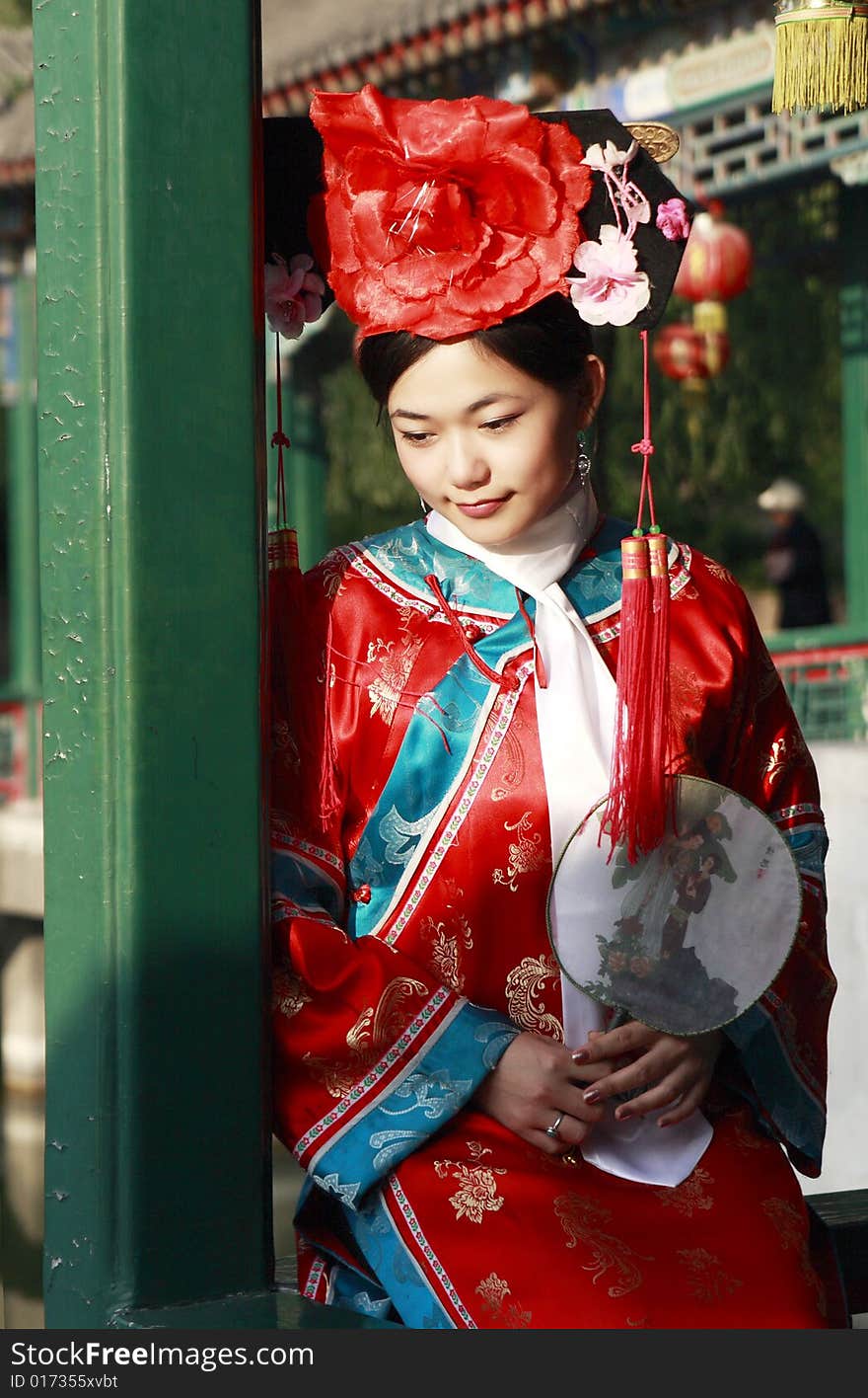 A beautiful girl in Chinese ancient dress is in the royal garden. This is dress of Qing Dynasty of China. It is the princess' dress too. Chinese on the fan is meant and missed. A beautiful girl in Chinese ancient dress is in the royal garden. This is dress of Qing Dynasty of China. It is the princess' dress too. Chinese on the fan is meant and missed.