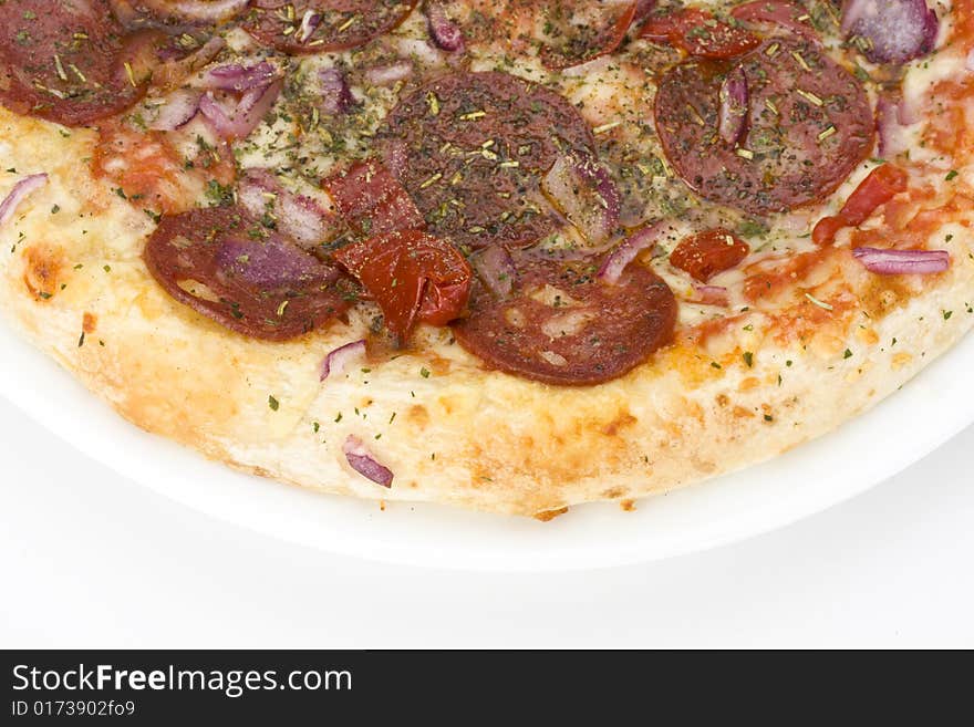 A pizza on a white plate over light grey background