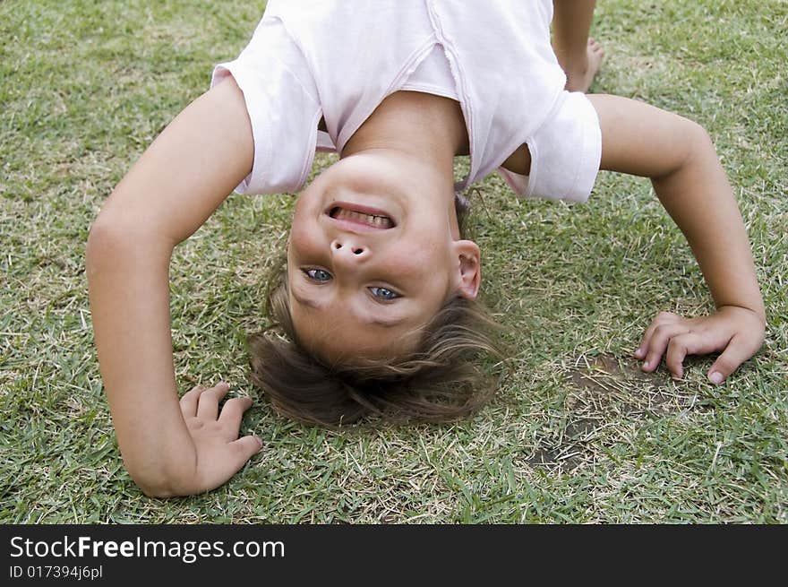 Girl Doing Cartwheel In The Grass