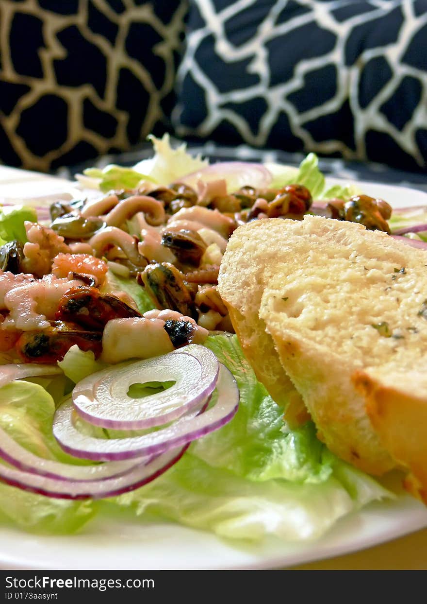 Plate of seafood salat on the table. Close up.