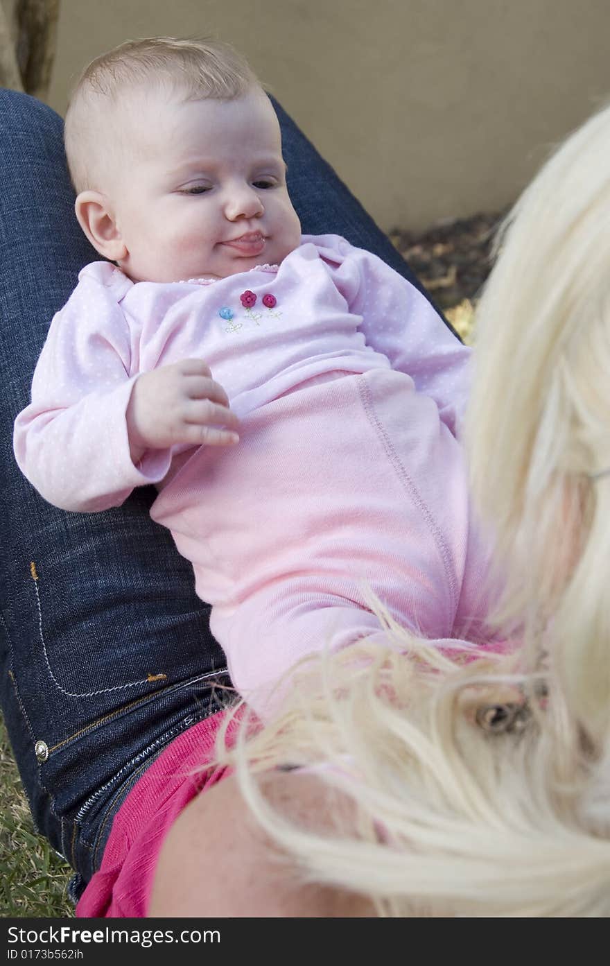 Young baby looking at her mother with curiosity. Young baby looking at her mother with curiosity