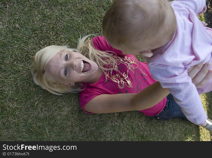 Beautiful mother playing with her newborn baby