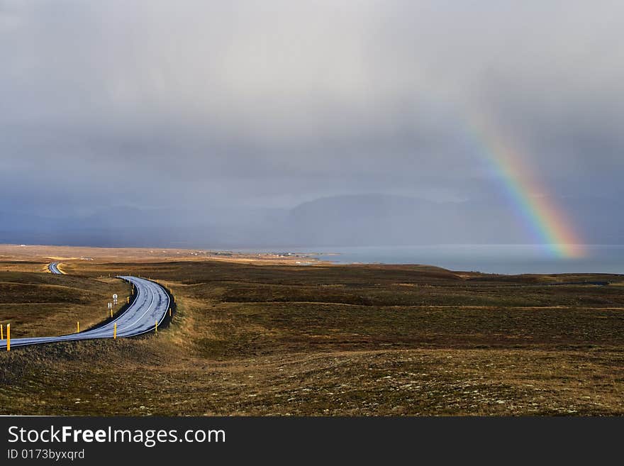 Landscape with rainbow and road