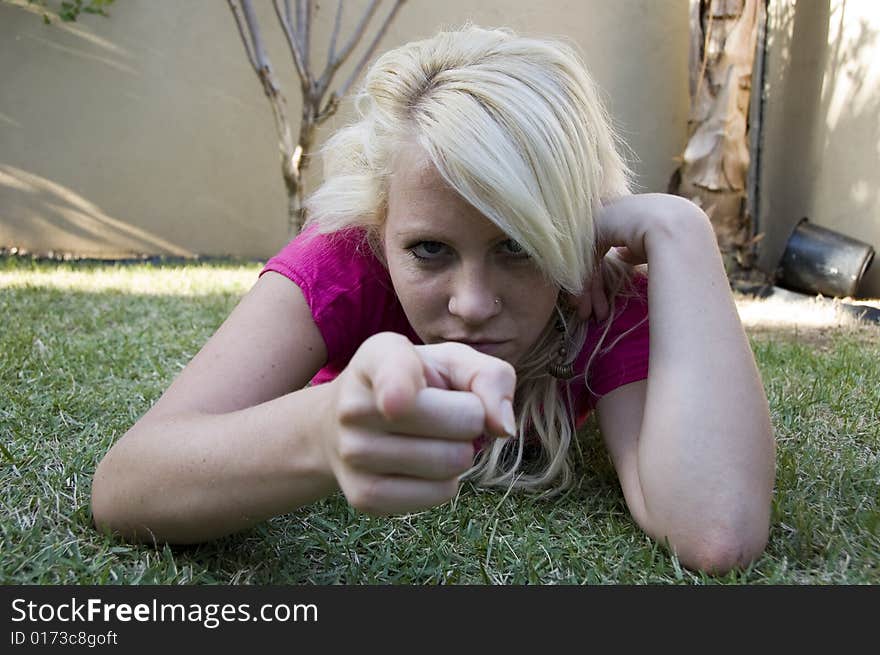 Caucasian woman pointing towards camera