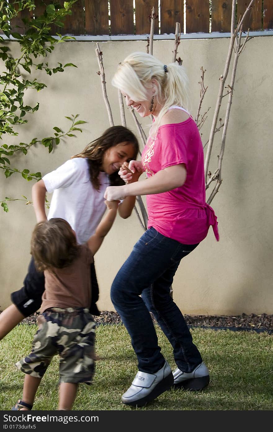 Mother playing with her sons in the lawn