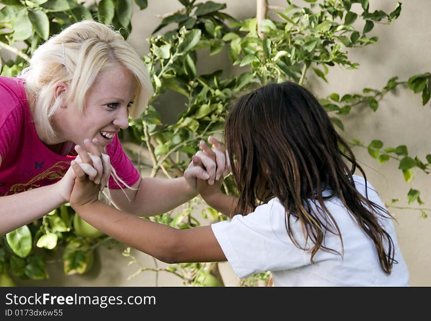 Young boy fighting with blonder woman on natural background. Young boy fighting with blonder woman on natural background