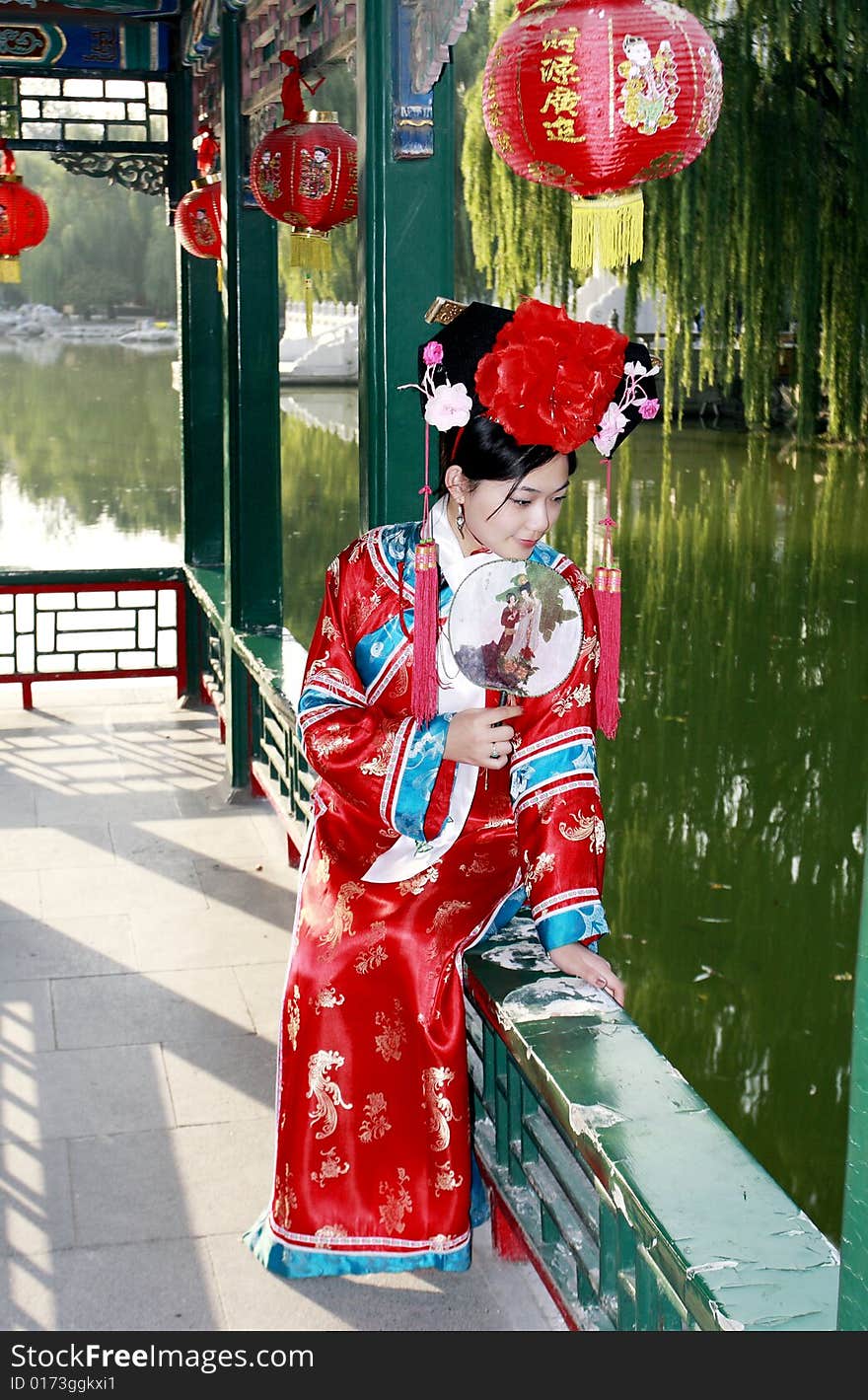 A beautiful girl in Chinese ancient dress is in the royal garden. Chinese on the lantern is lucky and getting rich. Chinese on the fan is meant and missed. A beautiful girl in Chinese ancient dress is in the royal garden. Chinese on the lantern is lucky and getting rich. Chinese on the fan is meant and missed.