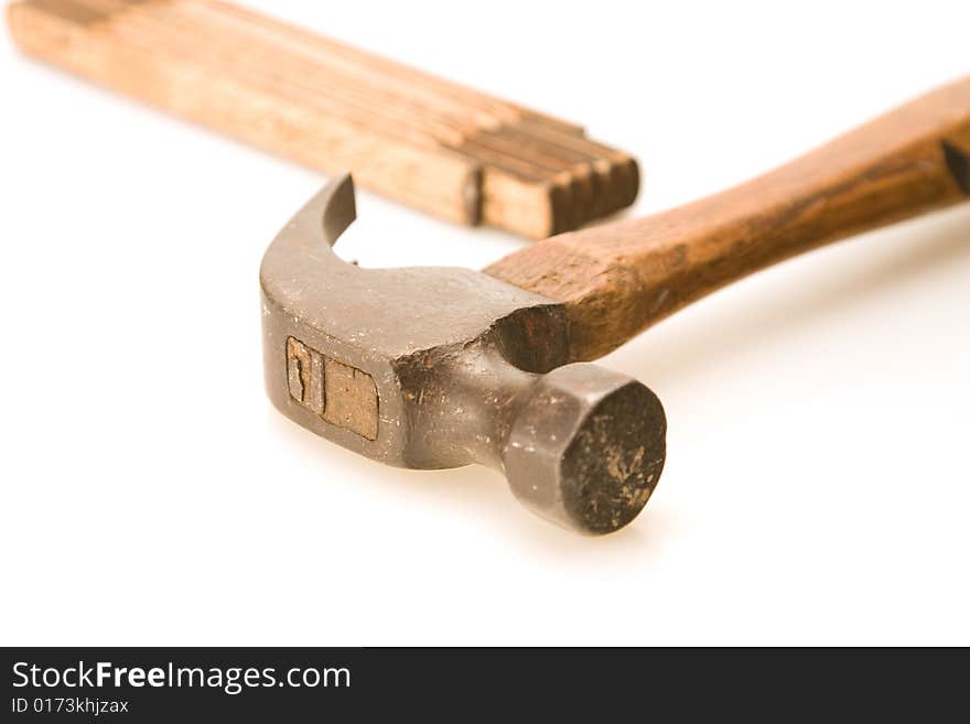 Hammer close up and folding tape measure background. Hammer close up and folding tape measure background