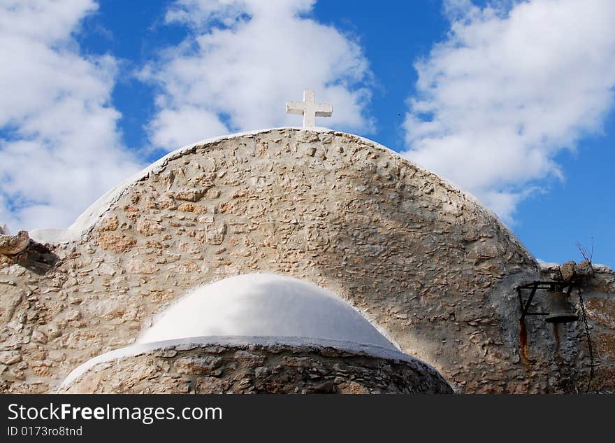 View of an old christian church in Cyprus against a blue cloudy sky. View of an old christian church in Cyprus against a blue cloudy sky