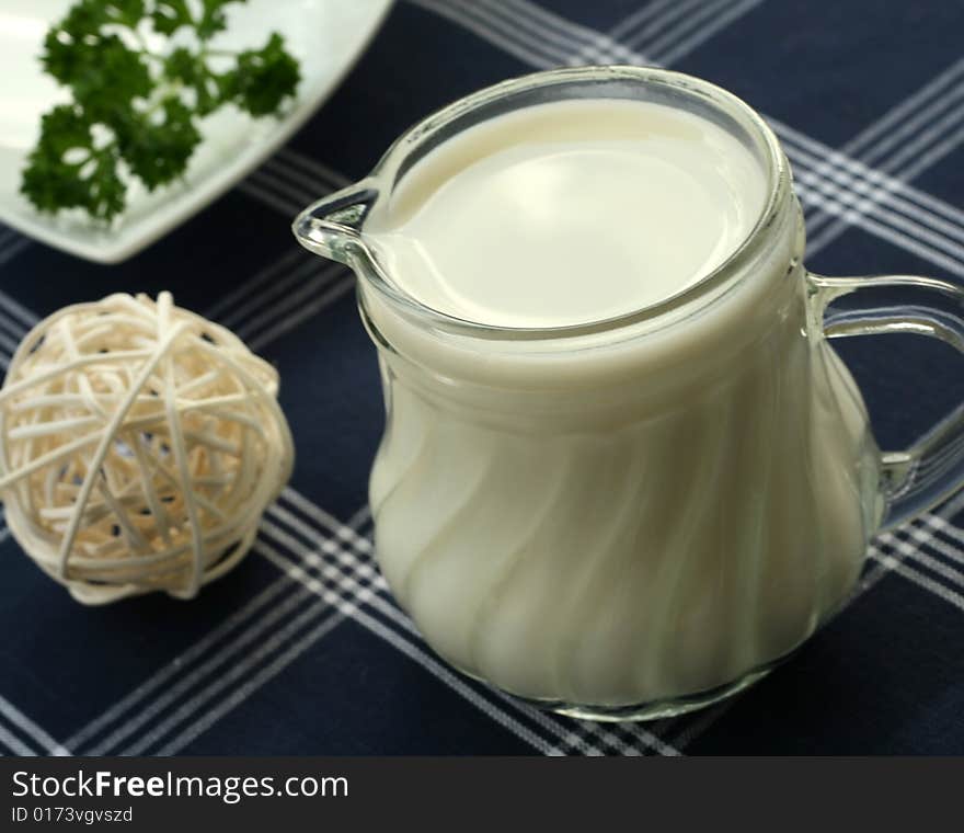 Milk Pitcher On The Blue Table Cover