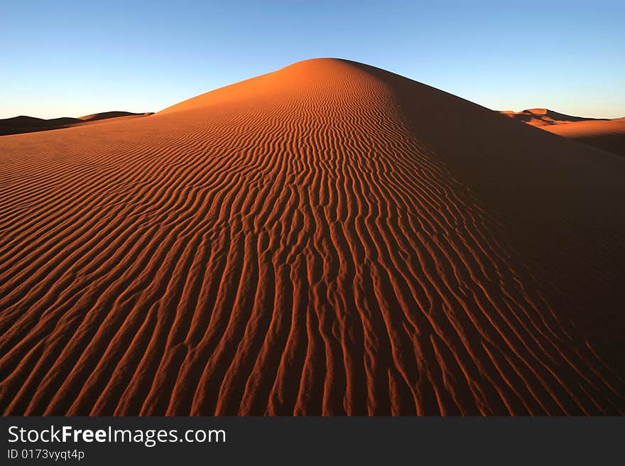 Morning light on the dune surface. Morocco. Morning light on the dune surface. Morocco.