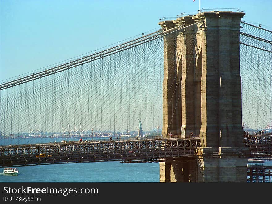 Statue of Liberty and Brooklyn Bridge bask in autumn sun. Statue of Liberty and Brooklyn Bridge bask in autumn sun.