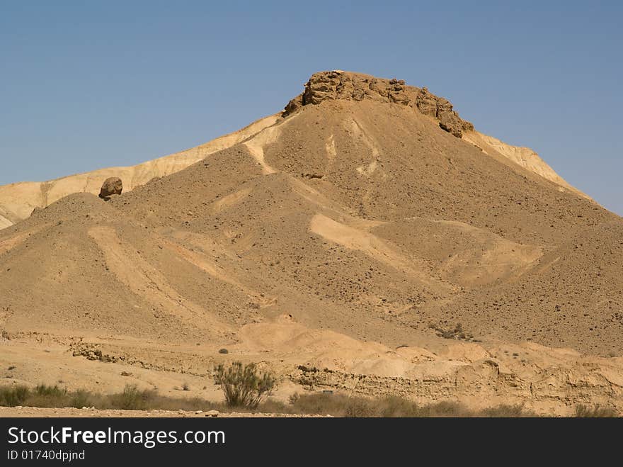 Rock and colored terrain in Big Crater, Negev desert, Israel.