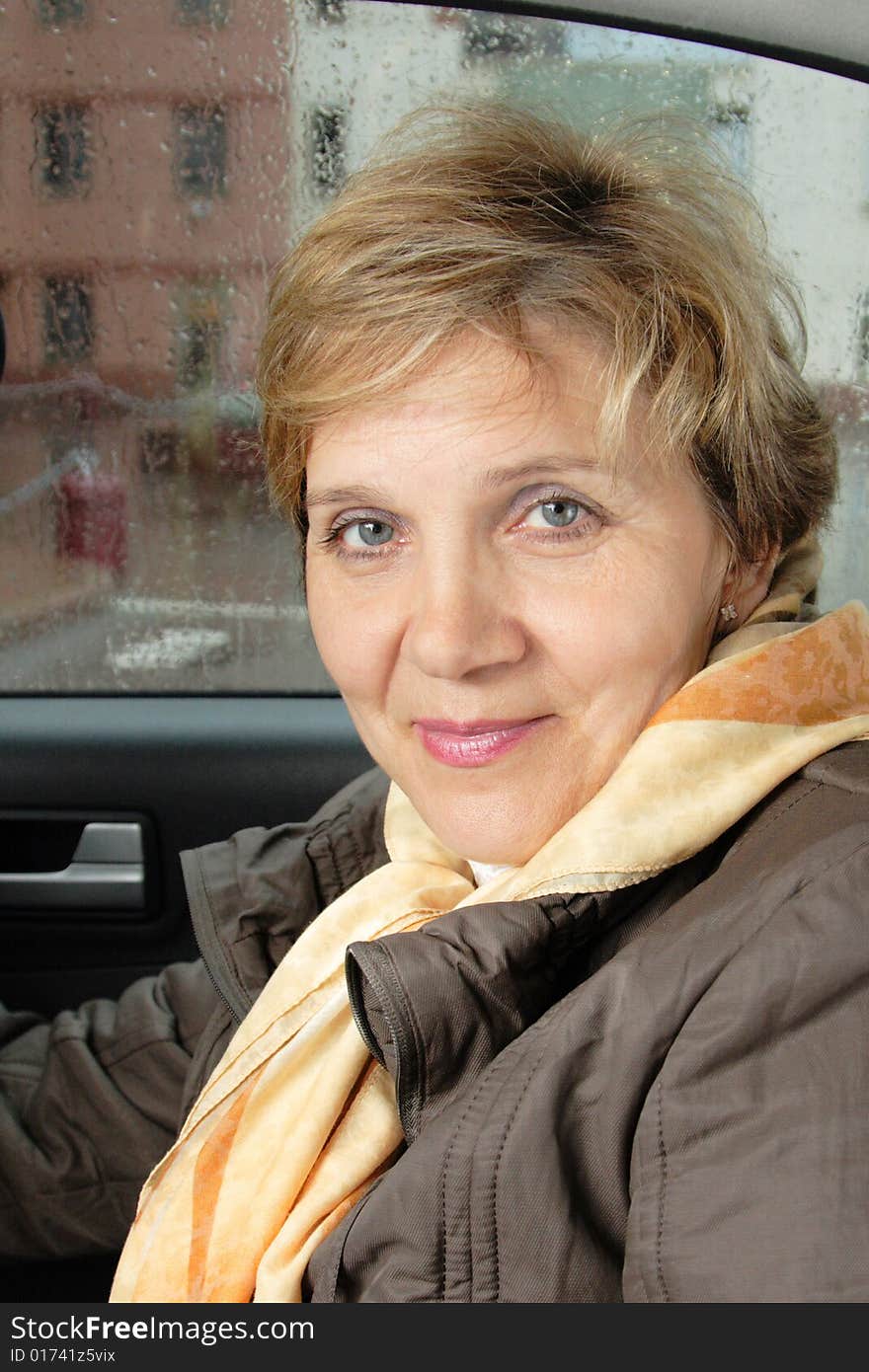 Portrait of attractive senior woman sitting in a car. Portrait of attractive senior woman sitting in a car