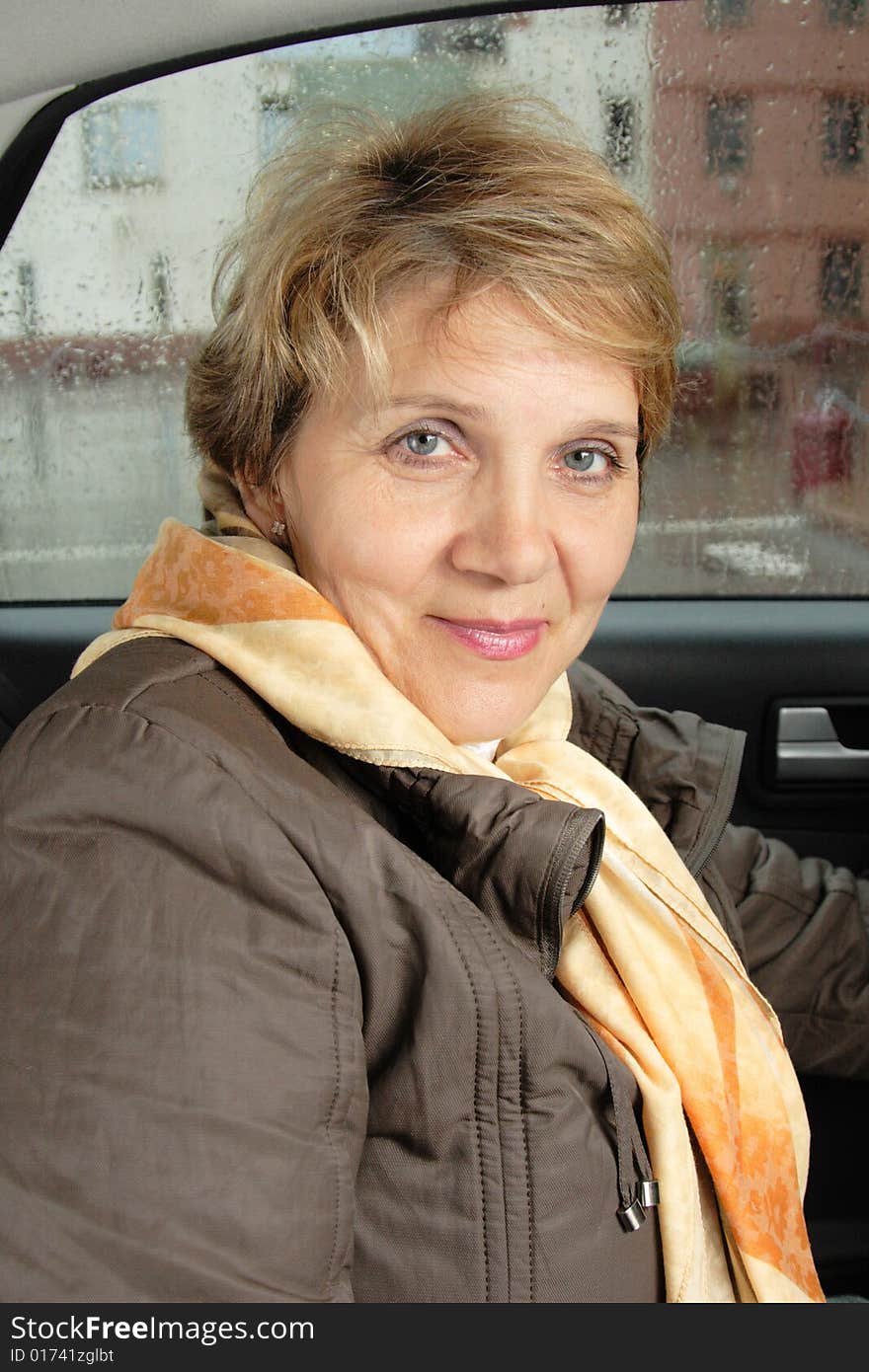 Portrait of attractive senior woman sitting in a car