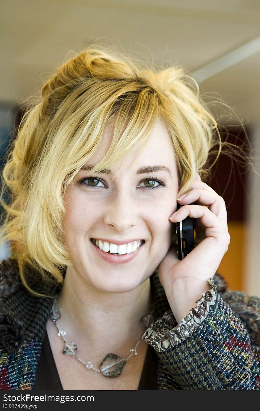 Young Blonde Caucasian Woman Answering Phone in Office