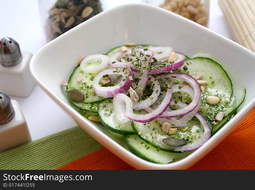 A fresh salad of cucumbers with some red onions