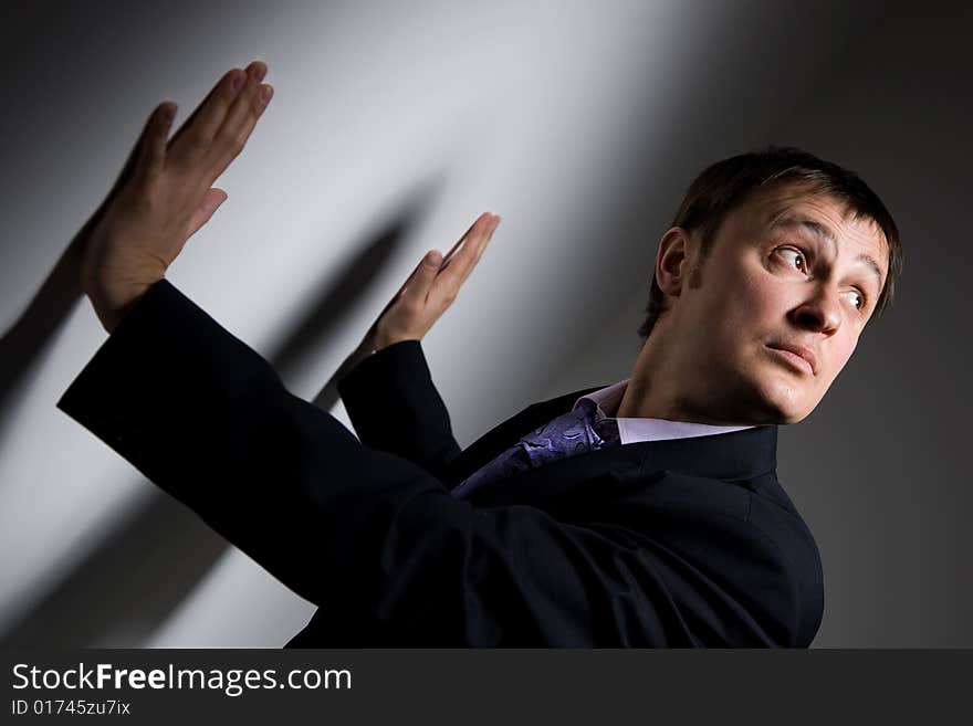 Man is standing near the wall and looking up. Man is standing near the wall and looking up